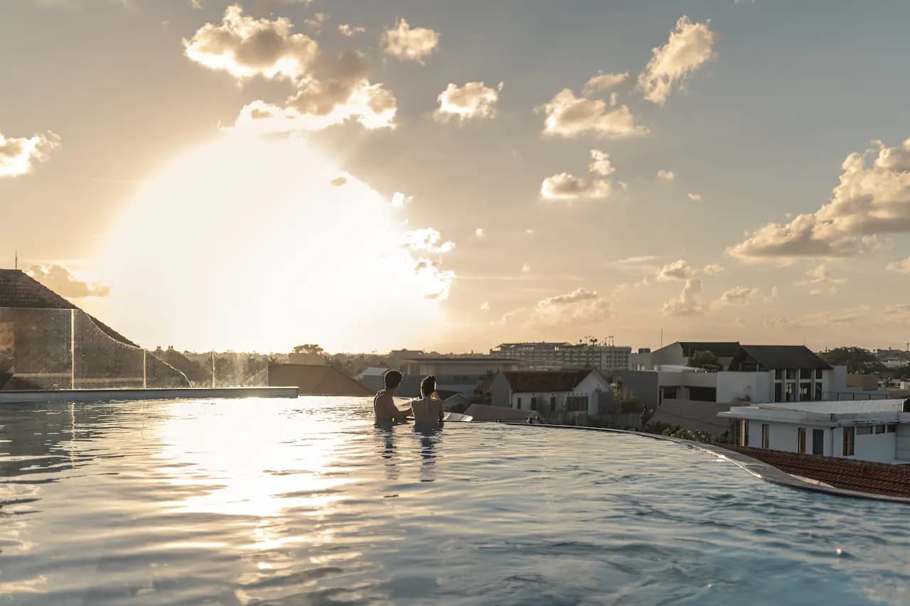 Guests enjoying a sunset swim in a Bali infinity pool